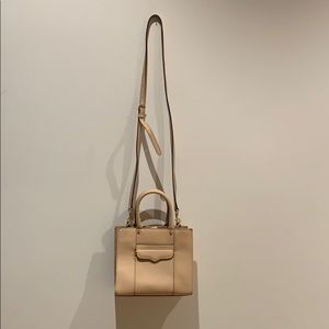 Chic, beige small Rebecca Miskoff crossbody bag.